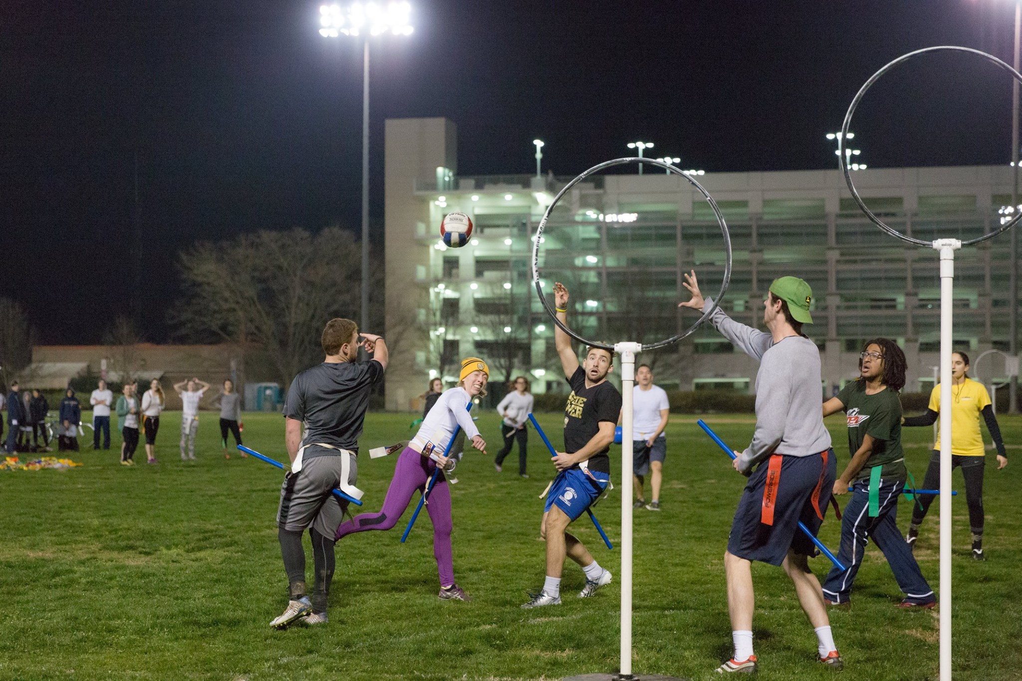 Campus Recreation athletes play quiditch on a UC Davis field after dark