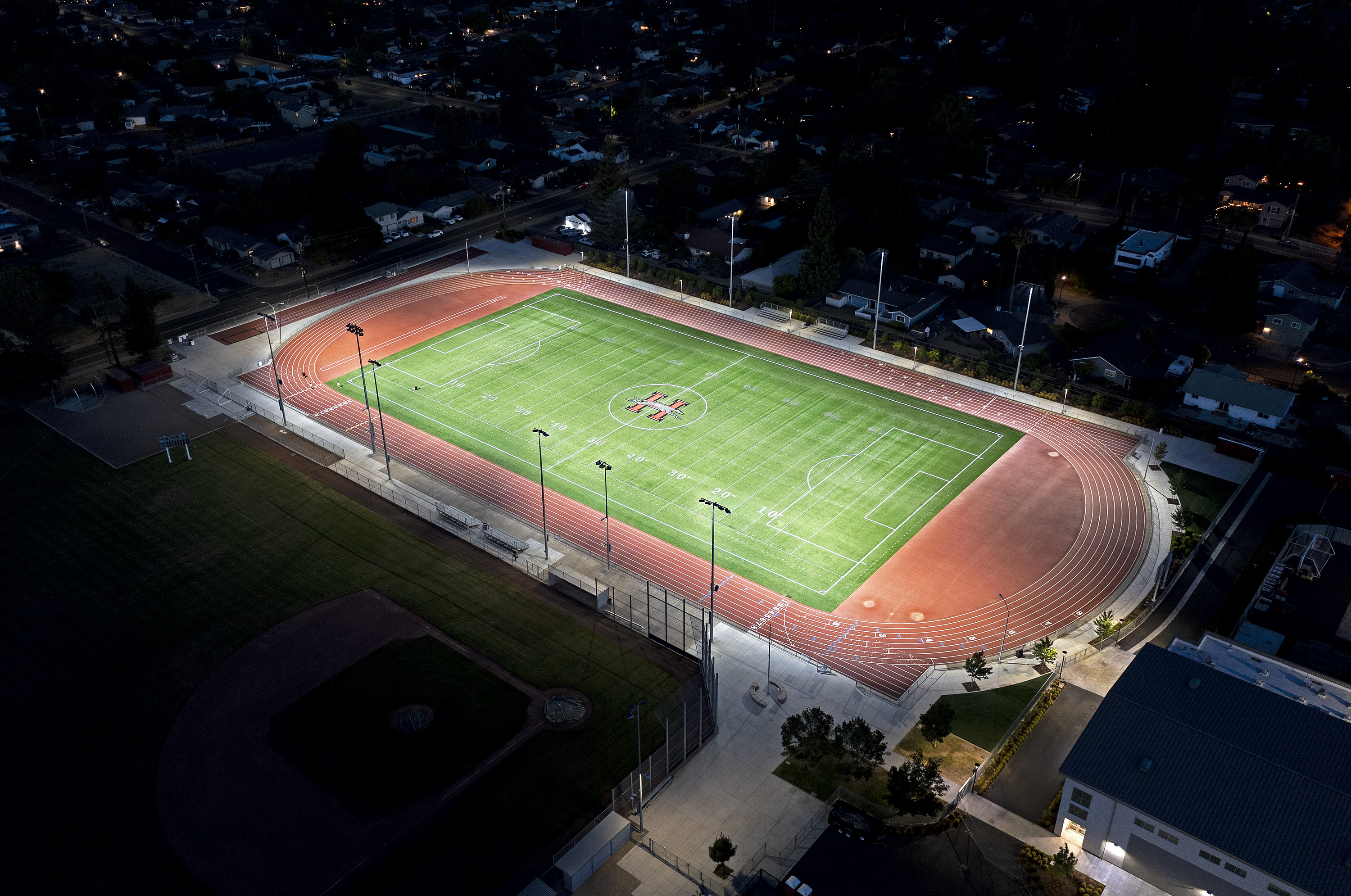Football field with lighting and minimal spillage to the houses in proximity